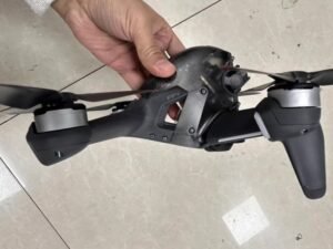 DJI FPV drone body only-no battery Side view of DJI FPV Drone body-only, includes propellers, no accessories.