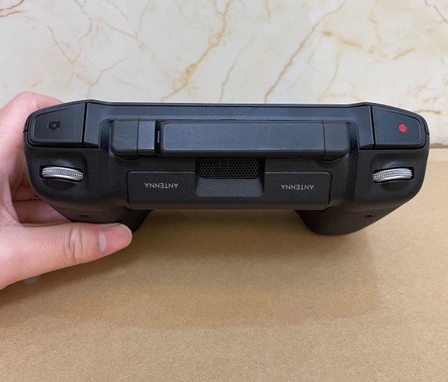 DJI RC Pro Smart Controller RM510 in hand controlling DJI Mavic 3 drone