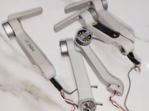Side angle of DJI Mini 4K motor arm replacement showing motor and connectors
