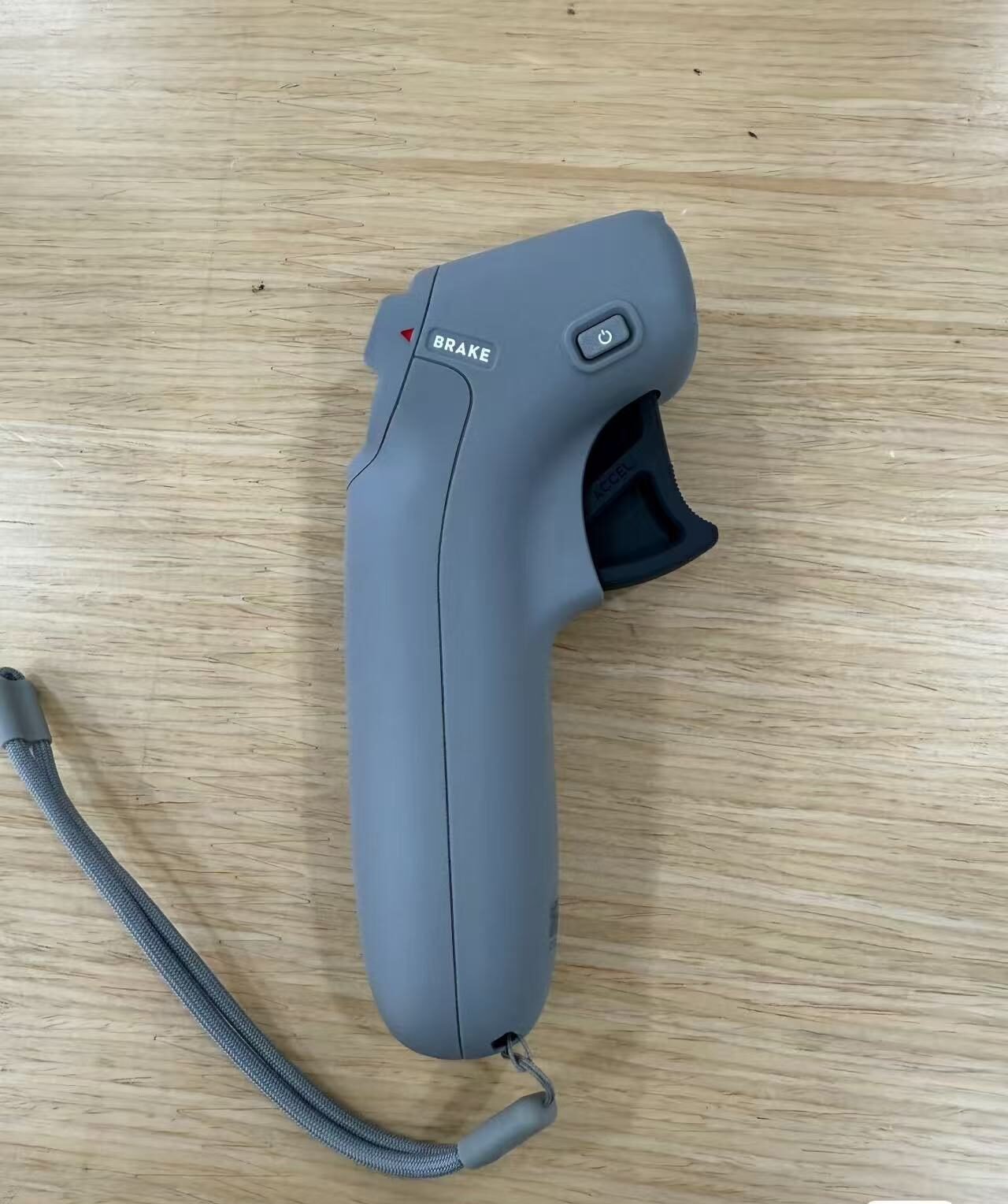 Side angle of DJI Motion Controller showing ergonomic grip and buttons