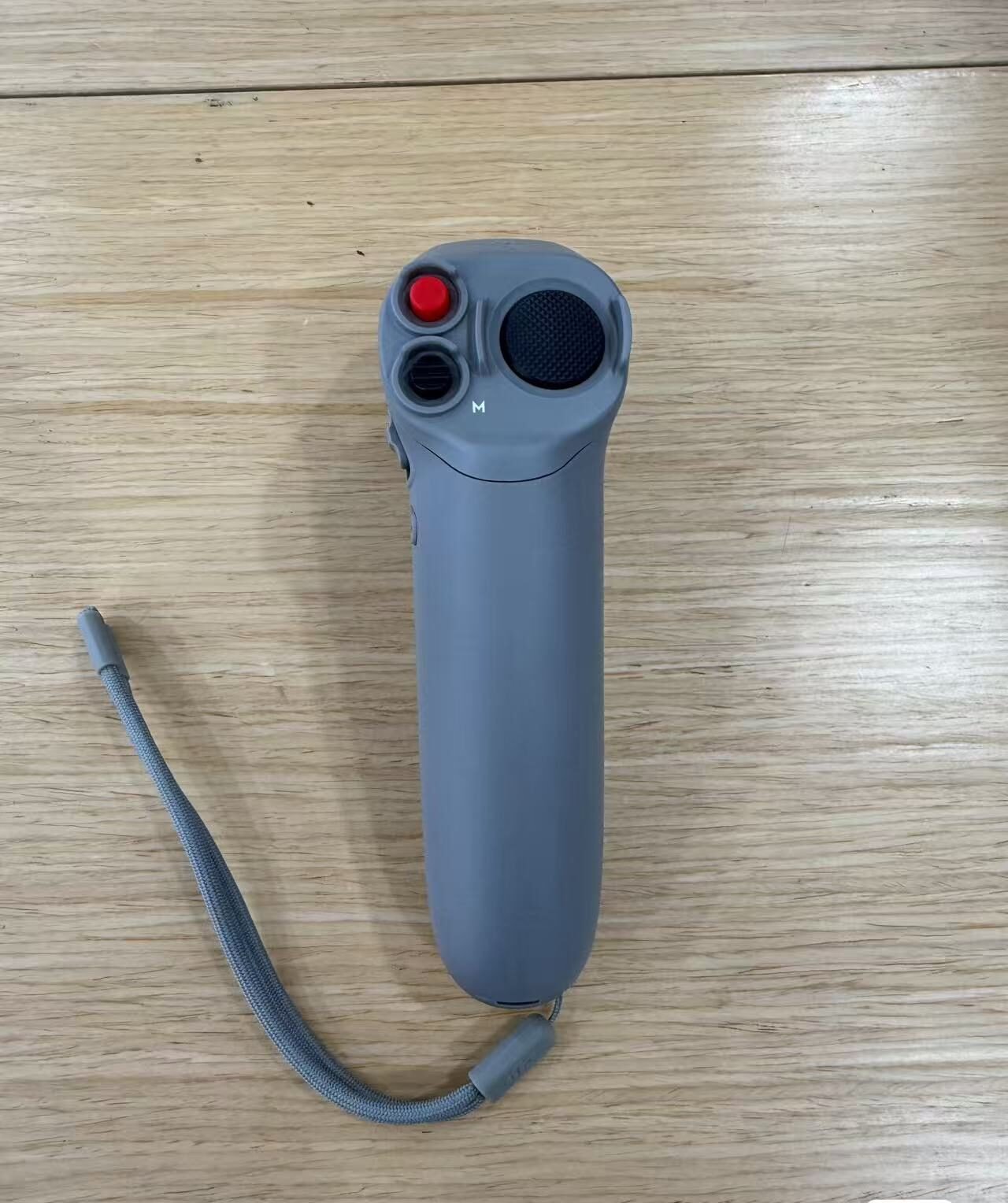 Close-up of DJI Motion Controller lanyard port and charging connector